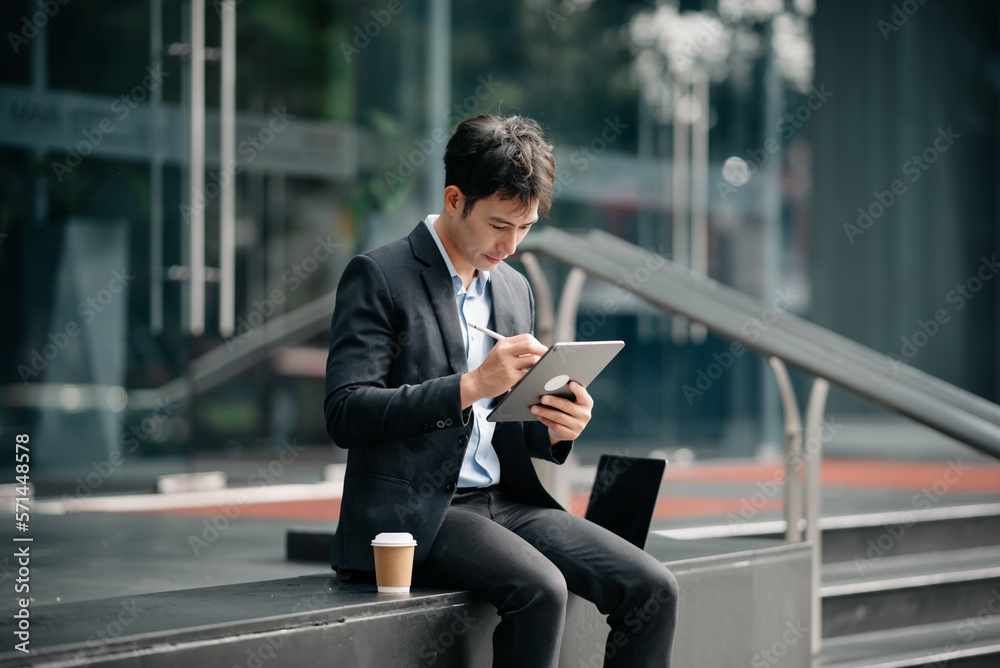 Portrait of a young man sitting at his street in the office. Portrait of a young man sitting at his street in the office.