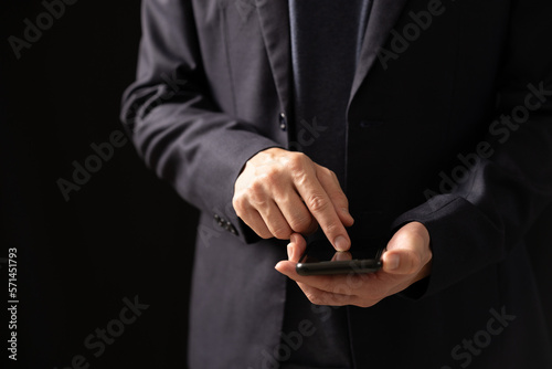 Close up of business man hand using mobile phone, searching the information during online working , internet networking, business planning, social media marketing © Smallroombigdream