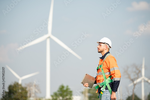Engineer at natural energy wind turbine site Must use a computer to control check for accuracy in work
