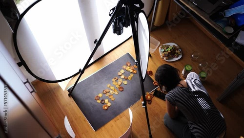 Photographer stoker taking a photo of dried fruit snack word on dark background photo