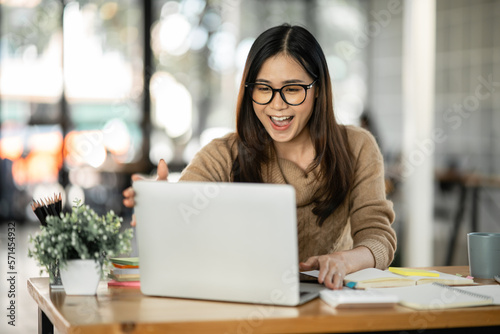 Asian woman happy with job success happy at home.