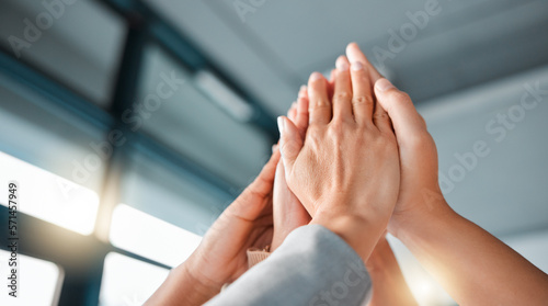 Hands, team and high five for collaboration, trust or unity in coordination or corporate goals at the office. Hands of group in teamwork celebration for partnership, agreement or community support