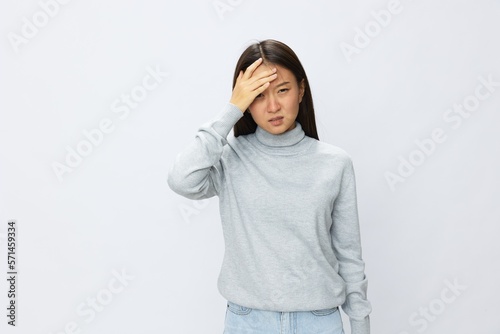 Asian woman holding her hand to her head for severe headache, migraine white background © SHOTPRIME STUDIO