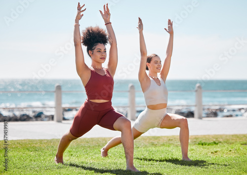 Yoga, fitness and beach with woman friends outdoor together in nature for wellness training. Exercise, chakra or zen with a female yogi and friend outside for a mental health workout by the ocean © T Mdlungu/peopleimages.com