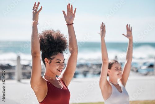 Yoga, exercise and beach with woman friends outdoor together in nature for wellness training. Fitness, chakra or zen with a female yogi and friend outside for a mental health workout by the ocean