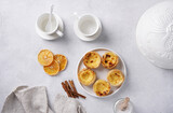 typical portuguese egg tart pastel de nata with cups for coffee on concrete background, top view