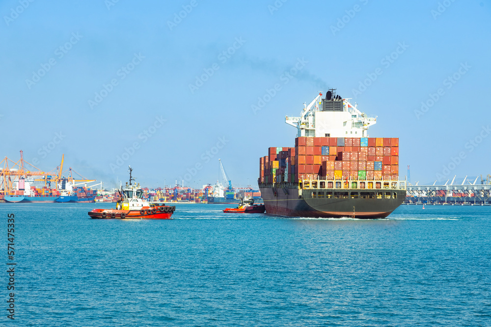 Fototapeta premium Large cargo container ship sails in the seaport