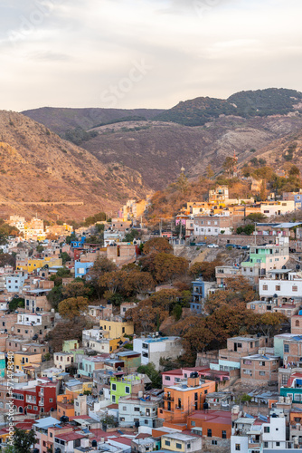 Very beautiful view of the city at sunset in the Mexican city of Guanajuato surrounded by large mountains. © nikwaller