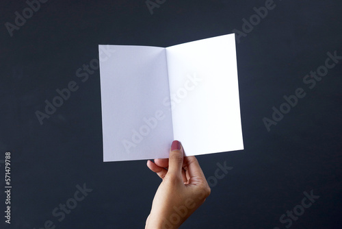 Hand opening A6 blank white brochure booklet mockup. Booklet design template.  photo