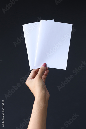 Hand holding Two Blank A6 Flyer. Invitation Book Mock-up. photo