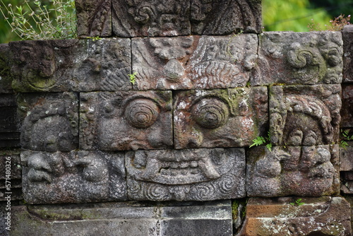 The relief of kala kirtimukha on penataran temple. Kala kīrttimukha is the name of a swallowing fierce monster face with huge fangs and a gaping mouth photo