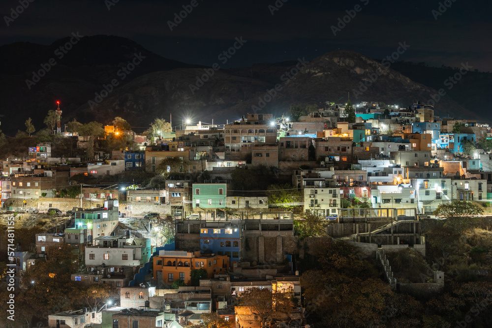 Beautiful view of the Mexican city of Guanajuato at night. City surrounded by large mountains.