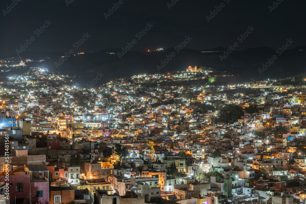 Beautiful view of the Mexican city of Guanajuato at night. City surrounded by large mountains.