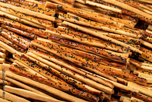 Pretzel bread sticks with sesame seeds. Delicious pretzels in bulk. close up