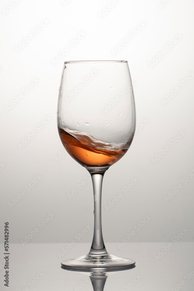 Splash of rose wine in glass, frozen motion Splash of rose wine in glass, frozen motion
