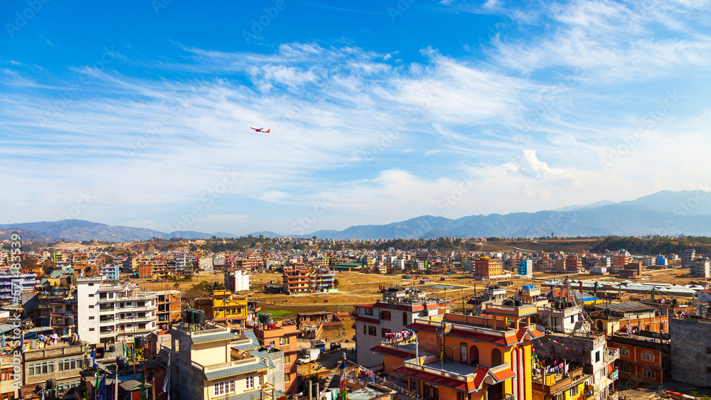 The airplane takes off from Kathmandu city, Nepal. Landscape of Kathmandu in winter blue sky. Aircraft take off from Tribhuvan international airport.One of the most dangerous air travel in the world.