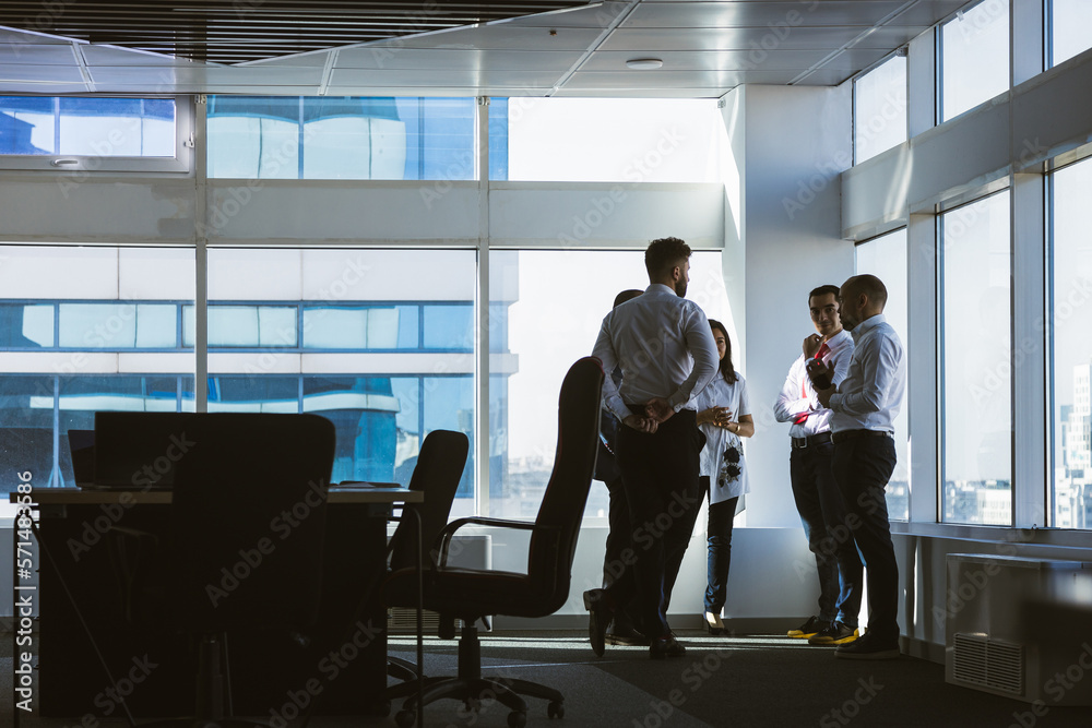 A team of young businessmen working and communicating together in an office. Corporate businessteam and manager in a meeting. A team of young businessmen working and communicating together in an office. Corporate businessteam and manager in a meeting.