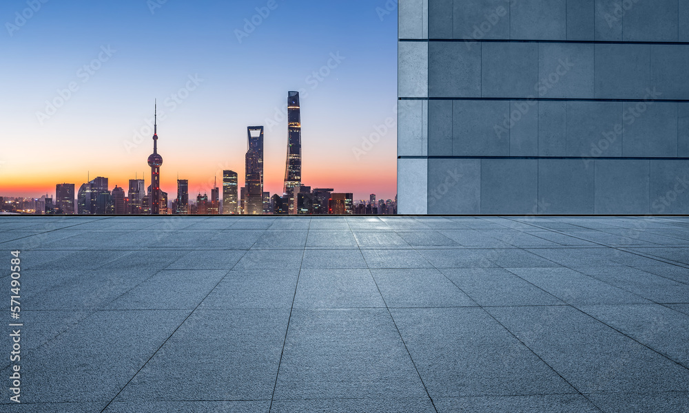 Empty square floor and city skyline with modern buildings at sunrise in Shanghai, China. Empty square floor and city skyline with modern buildings at sunrise in Shanghai, China.