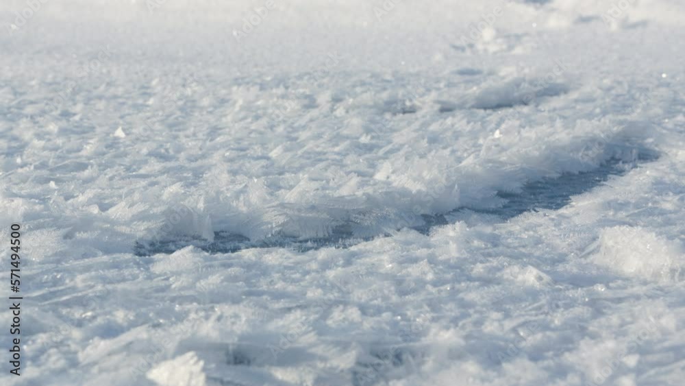 Snow lies on the ground, sunny winter day, low shooting angle in macro Snow lies on the ground, sunny winter day, low shooting angle in macro