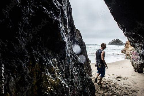 Climber bouldering on beach in san Francisco photo