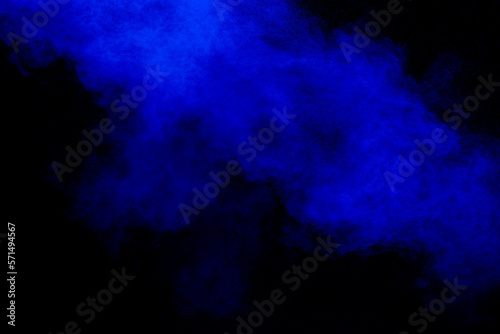Blue dust explosion on black background. Freeze motion of color powder splash. © Pattadis