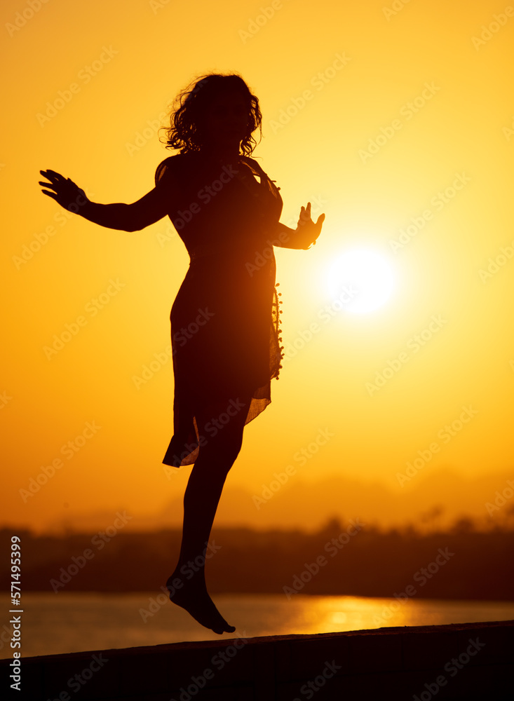 Silhouette of a girl in a jump.