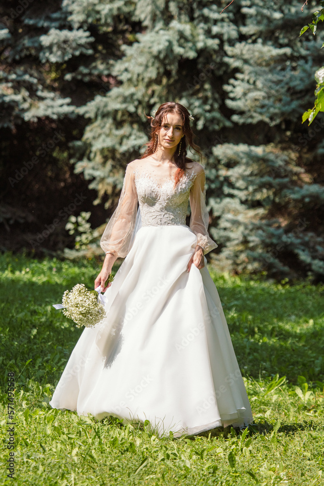 Girl in a wedding dress in nature.