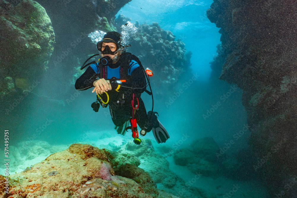 scuba diver exploring a canyon at the great barrier reef in Australia scuba diver exploring a canyon at the great barrier reef in Australia