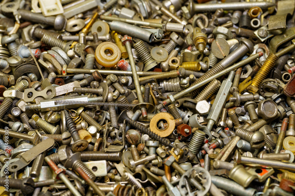 Background of screw bolts, nuts, many screws. A set of screws, bolts, nuts and other homemade fasteners. Slight sharpness of roughness, possible graininess. Shallow depth of field, soft selective focu Background of screw bolts, nuts, many screws. A set of screws, bolts, nuts and other homemade fasteners. Slight sharpness of roughness, possible graininess. Shallow depth of field, soft selective focu