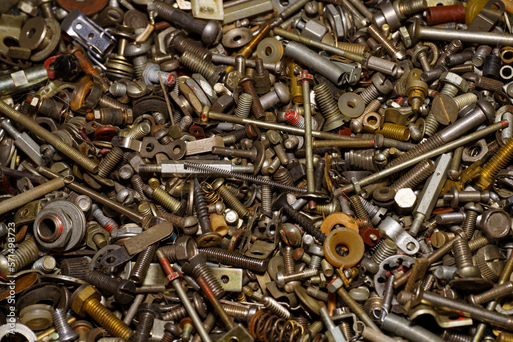 Background of screw bolts, nuts, many screws. A set of screws, bolts, nuts and other homemade fasteners. Slight sharpness of roughness, possible graininess. Shallow depth of field, soft selective focu Background of screw bolts, nuts, many screws. A set of screws, bolts, nuts and other homemade fasteners. Slight sharpness of roughness, possible graininess. Shallow depth of field, soft selective focu
