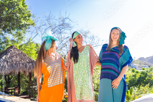 Happy group of models with tribal dresses smiling outdoors