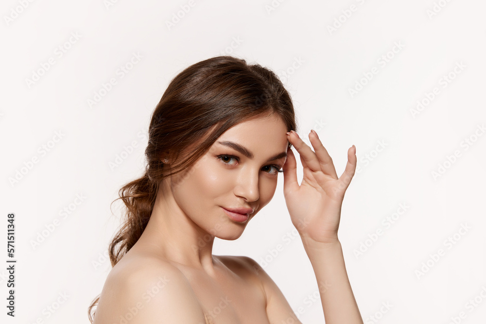 Portrait of young beautiful woman with perfect smooth skin isolated over white background. Attraction and femininity. Concept of natural beauty, plastic surgery, cosmetology, cosmetics, skin care. Portrait of young beautiful woman with perfect smooth skin isolated over white background. Attraction and femininity. Concept of natural beauty, plastic surgery, cosmetology, cosmetics, skin care.