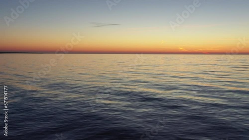 Aerial drone flight captures stunning beach sunset with its bird life and waves photo