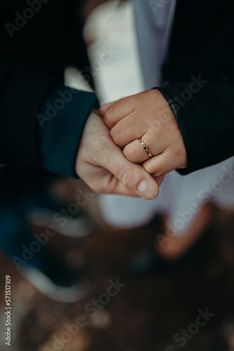 Couple holds engagement ring © Luk