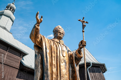 Monument of John Paul II and wooden church st. Bartholomew in Zdzary, Lodz Voivodeship, Poland photo