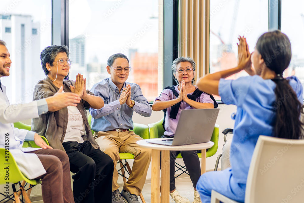 Portrait of asian woman physiotherapist trainer carer helping physical and discussing consulting talk with group asian senior patient by doing yoga workout exercises in rehabilitation at hospital Portrait of asian woman physiotherapist trainer carer helping physical and discussing consulting talk with group asian senior patient by doing yoga workout exercises in rehabilitation at hospital