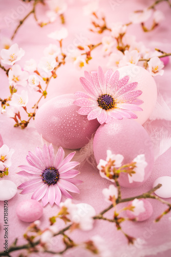 Easter eggs and pink flowers on pink background. Easter  and spring concept