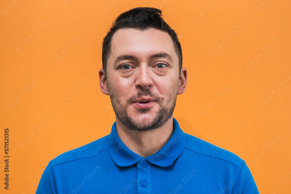 Portrait of the man on orange background. Man's emotions