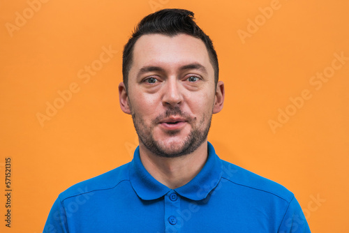 Portrait of the man on orange background. Man's emotions