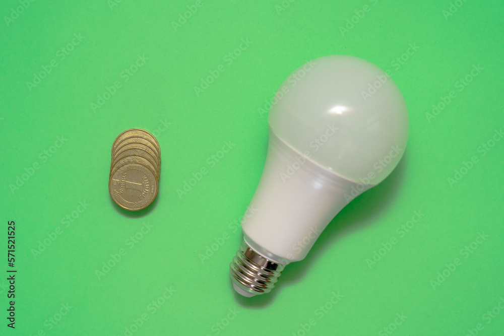 Energy saving light bulb with coins money. Savings Energy saving light bulb with coins money. Savings