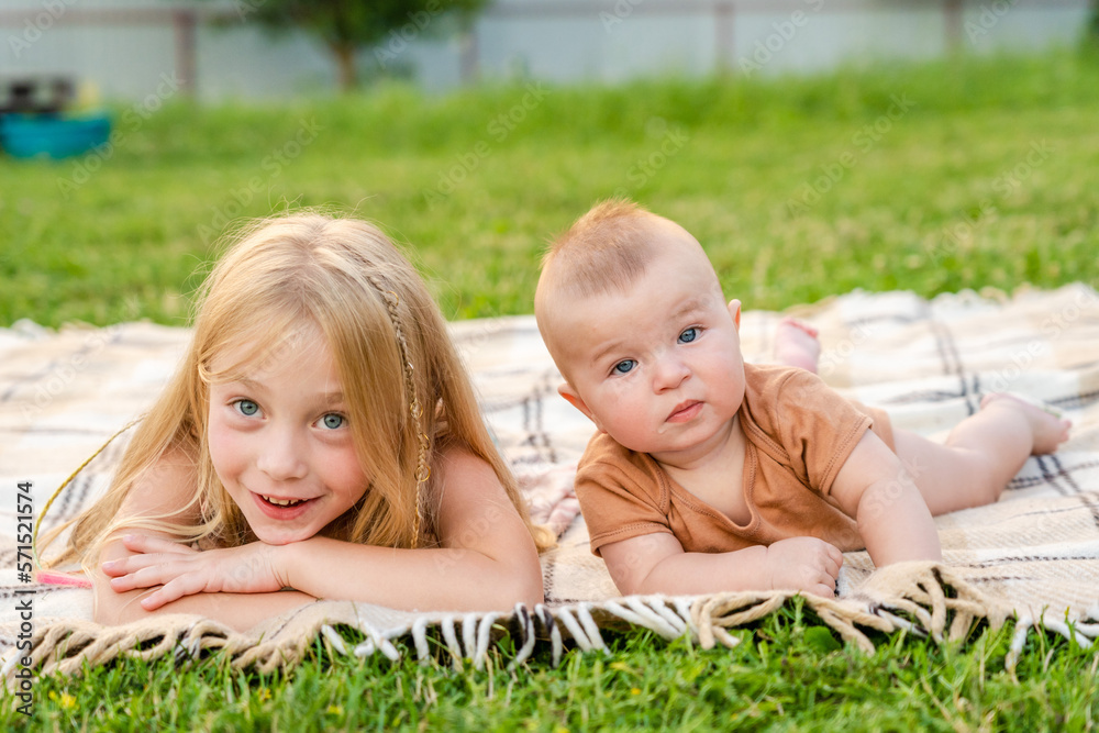 Cute childrens lying on a blanket at summer Cute childrens lying on a blanket at summer