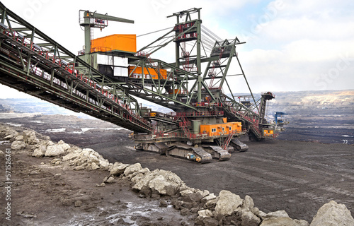 Bucket-wheel excavator during excavation at the surface mine. Huge excavator on open pit mine.