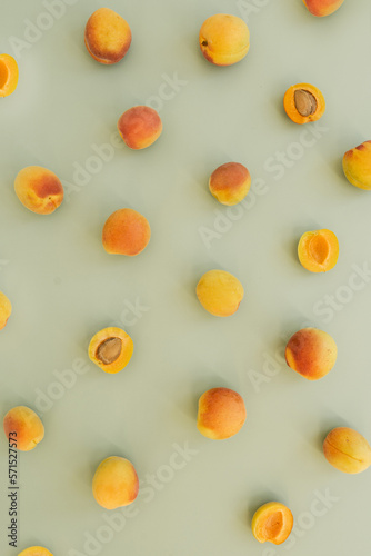 Flat lay with ripe peaches on neutral pastel green surface