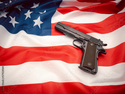 A handgun on the American flag background