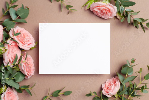 Wedding invitation or greeting card mockup with roses and eucalyptus flowers
