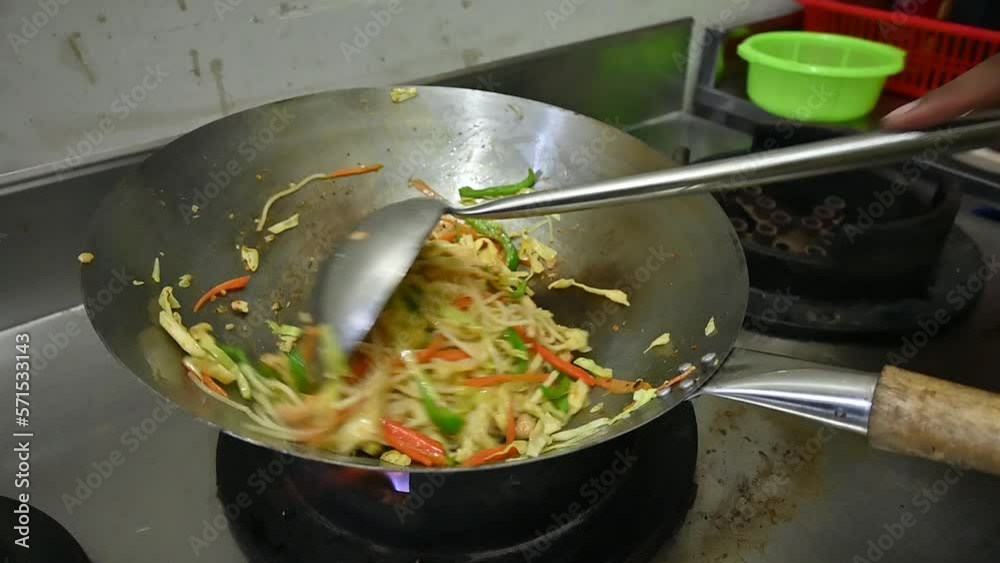 Chef Stirring Vegetable Stir Fry Noodles In Wok With Ladle. Slow Motion Chef Stirring Vegetable Stir Fry Noodles In Wok With Ladle. Slow Motion