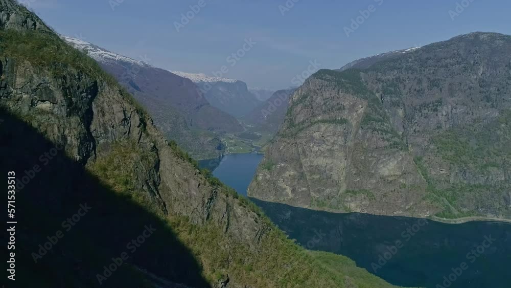 Aerial view of mountains with blue water lake and bluish sky in the background Aerial view of mountains with blue water lake and bluish sky in the background
