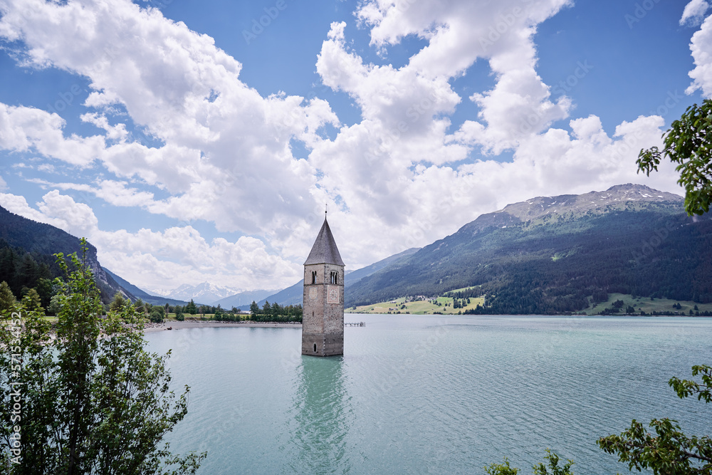 Beautiful view of the lake Resia. Famous tower in the water. Alps, Italy, Europe.