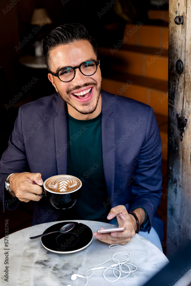 Mexican man in a coffee shop working online Mexican man in a coffee shop working online