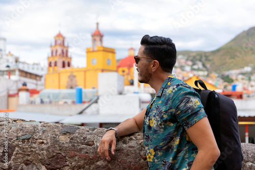 Mexican man traveling in Guanajuato. Student exploring a colorful city. 